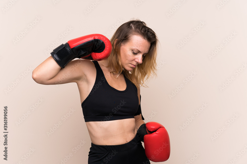 Blonde sport woman over isolated background with boxing gloves