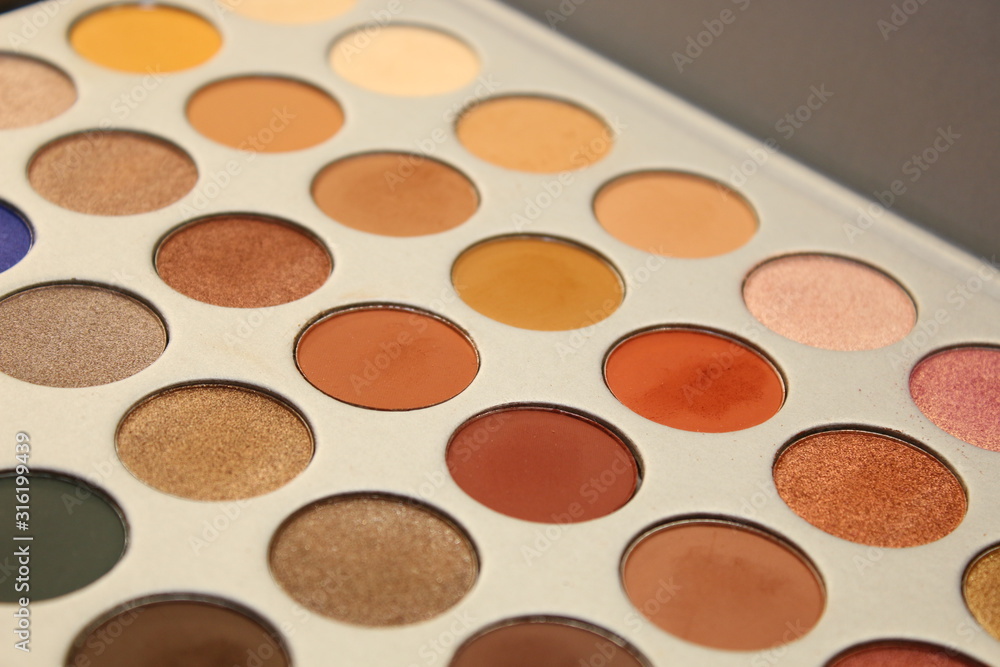 Fototapeta premium makeup palettes on wooden background, closeup