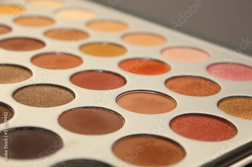  makeup palettes on wooden background, closeup
