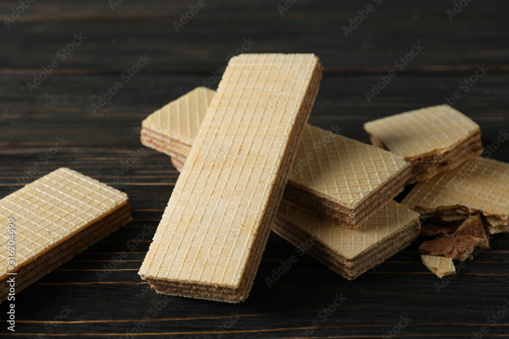 Sweet wafer biscuits on wooden background, close up