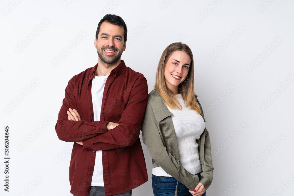 Couple in Valentine Day over isolated background keeping arms crossed Couple in Valentine Day over isolated background keeping arms crossed
