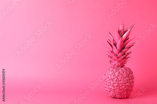 Painted pineapple on pink background, space for text
