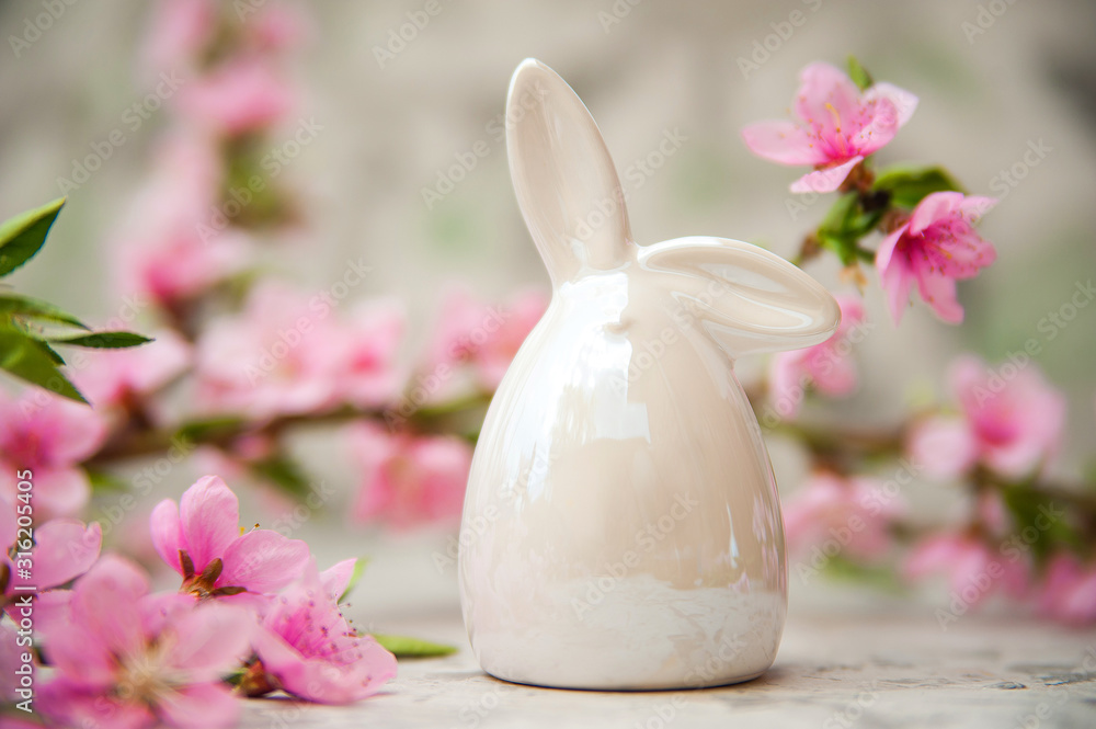 Spring photo of a blossoming tree and Easter eggs close-up and copy space. Easter card concept with bunny and eggs. Trending pink shades.