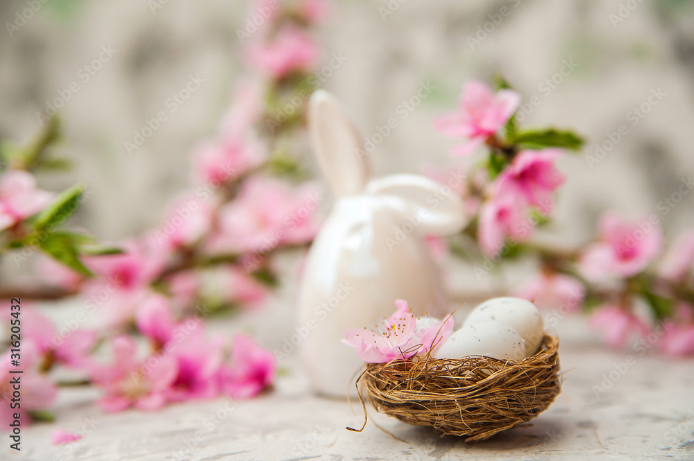 Spring photo of a blossoming tree and Easter eggs close-up and copy space. Easter card concept with bunny and eggs. Trending pink shades. Spring photo of a blossoming tree and Easter eggs close-up and copy space. Easter card concept with bunny and eggs. Trending pink shades.