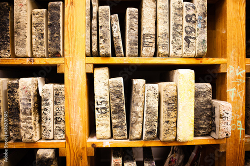 Принти на полотні In the workshop for lithography.  Lithography stone on shelf