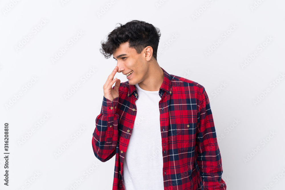 Young Argentinian man over isolated white background smiling a lot Young Argentinian man over isolated white background smiling a lot