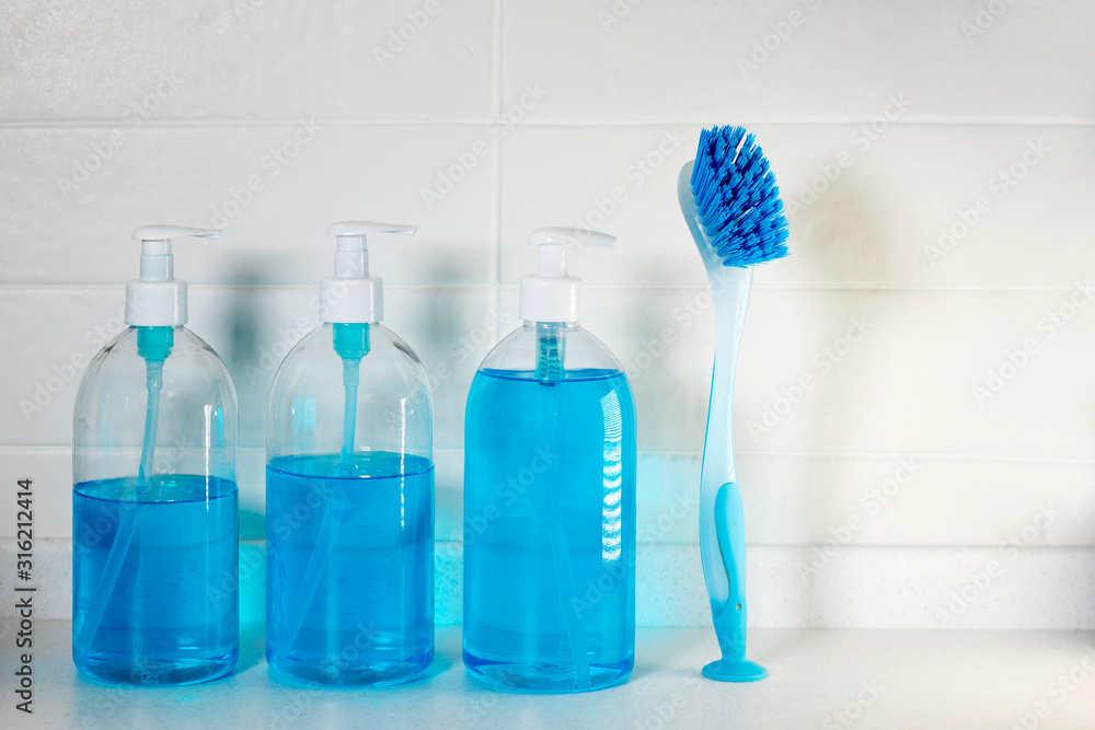 Liquid blue soap with dispenser in a plastic bottle and a brush for cleaning ceramics Liquid blue soap with dispenser in a plastic bottle and a brush for cleaning ceramics