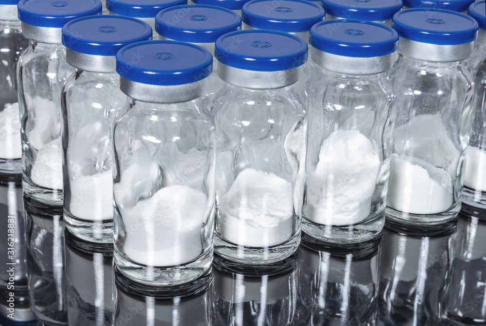 Glass vials with powder medication vaccine close up Glass vials with powder medication vaccine close up