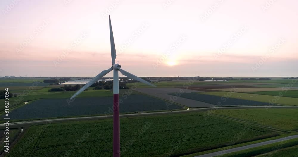 Static Shot of Turbine on a Wind Farm Producing Renewable Green Energy During Sunset, - Barradeel, Friesland, The Netherlands – 4K Drone Footage Static Shot of Turbine on a Wind Farm Producing Renewable Green Energy During Sunset, - Barradeel, Friesland, The Netherlands – 4K Drone Footage