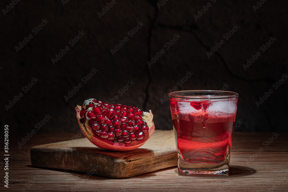 pomegranate and glass of pomegranate juice on wooden background pomegranate and glass of pomegranate juice on wooden background