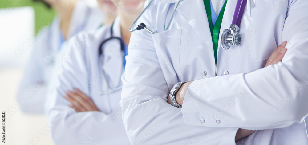 Happy medical team comprising male and female doctors smiling broadly