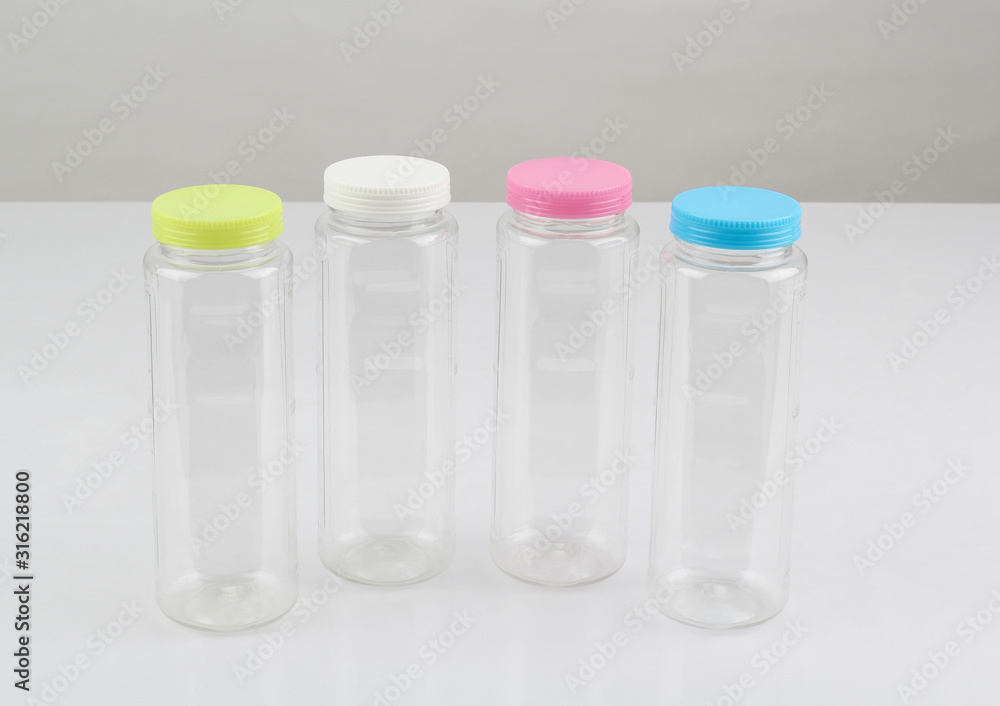 plastic water bottles with colorful lids isolated on white plastic water bottles with colorful lids isolated on white