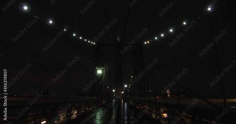 Walking on the Brooklyn Bridge at late night in New York. Walking on the Brooklyn Bridge at late night in New York.