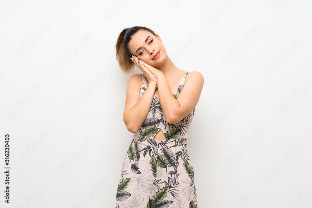 Young woman over isolated white background making sleep gesture in dorable expression Young woman over isolated white background making sleep gesture in dorable expression