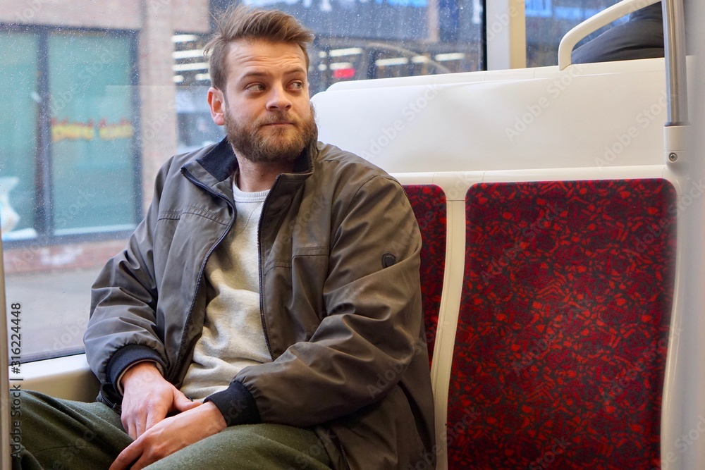 Man with a beard riding the streetcar downtown Toronto Man with a beard riding the streetcar downtown Toronto