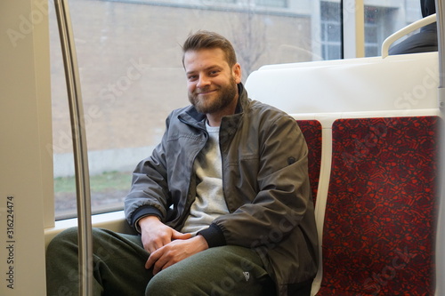 Man with a beard riding the streetcar downtown Toronto