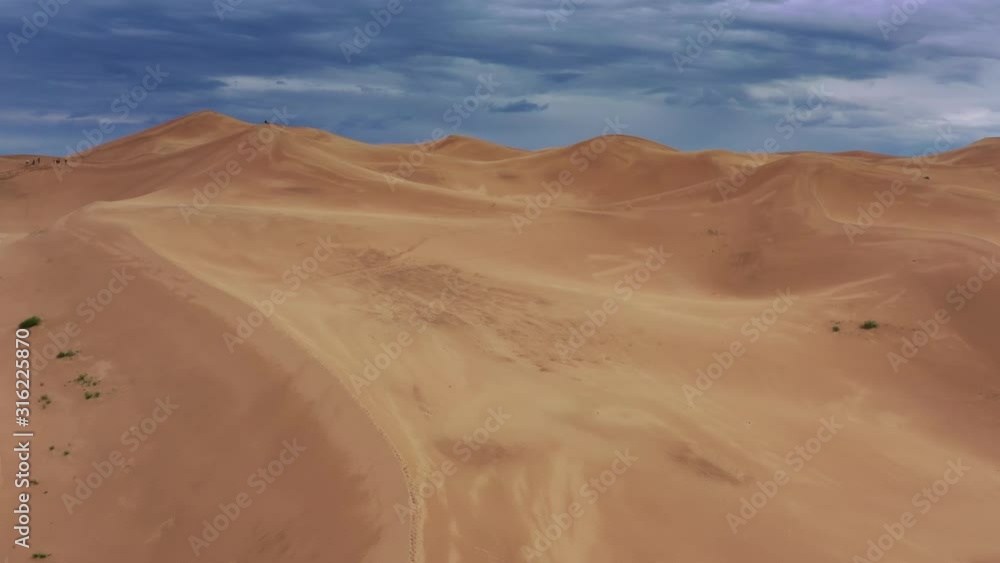 Aerial view on sand dunes under a gloomy cloudy sky in Gobi Desert, Mongolia, 4k Aerial view on sand dunes under a gloomy cloudy sky in Gobi Desert, Mongolia, 4k