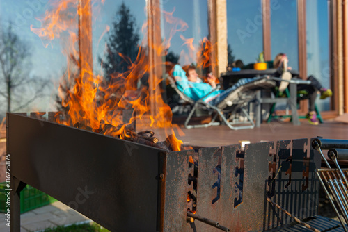 barbecue grill with fire flames outdoors. lnch or dinner photo