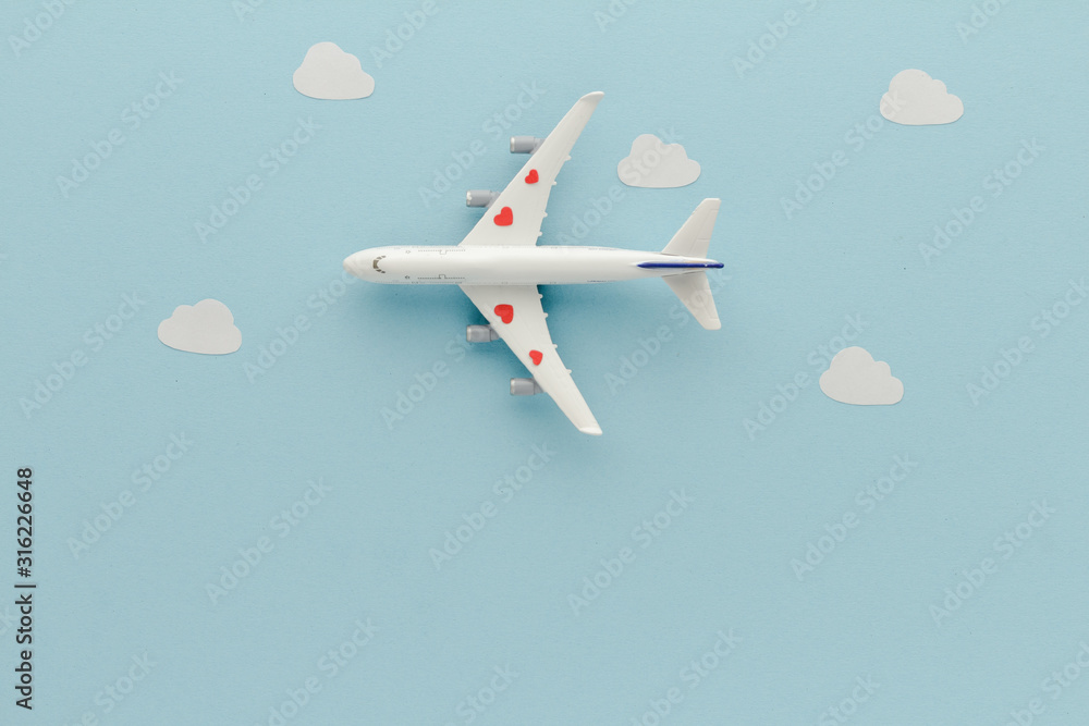 White top view Airplane .Airplane hearts clouds blue cloud sky background with copy space for your text. Flat lay. White top view Airplane .Airplane hearts clouds blue cloud sky background with copy space for your text. Flat lay.