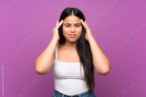 Young teenager Asian girl over isolated purple background unhappy and frustrated with something. Negative facial expression