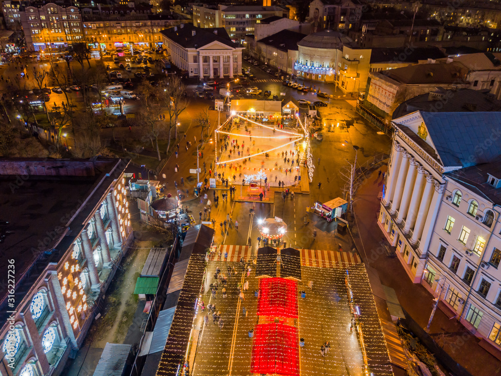 Aerial drone view. Skating rink on the square in Kiev. as night