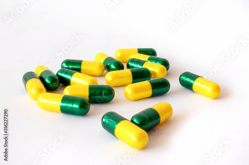 Yellow-green capsule, isolated on a white background.
