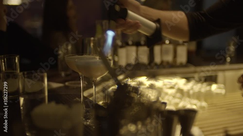 Bartender making cocktails on the bar table. barman shaking cocktails in the bar. Process of making cocktails in the modern restaurant bar