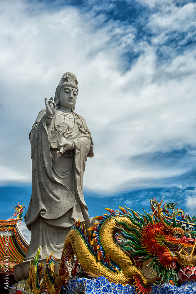 Fototapeta premium Big Standing Guan Yin and dragon in Suratthani,Thailand,Photo taken on:August 10th 2014