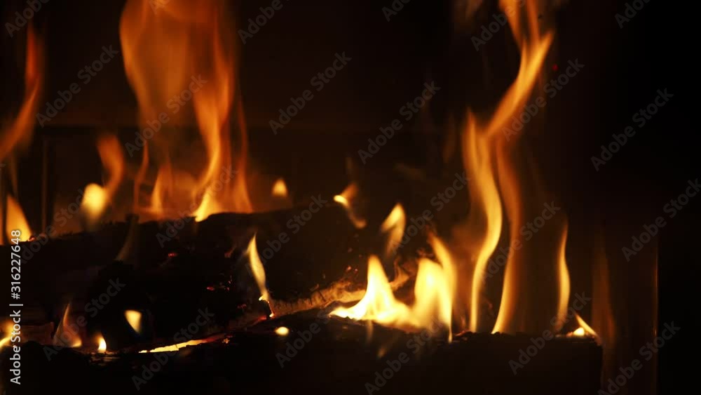 Wood Burning in a Fireplace. Warm cozy fire in a Fireplace. Home cosiness. Flames of fire on black background 4k Footage Wood Burning in a Fireplace. Warm cozy fire in a Fireplace. Home cosiness. Flames of fire on black background 4k Footage