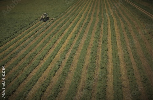 Aerial view above tractor working on a field 