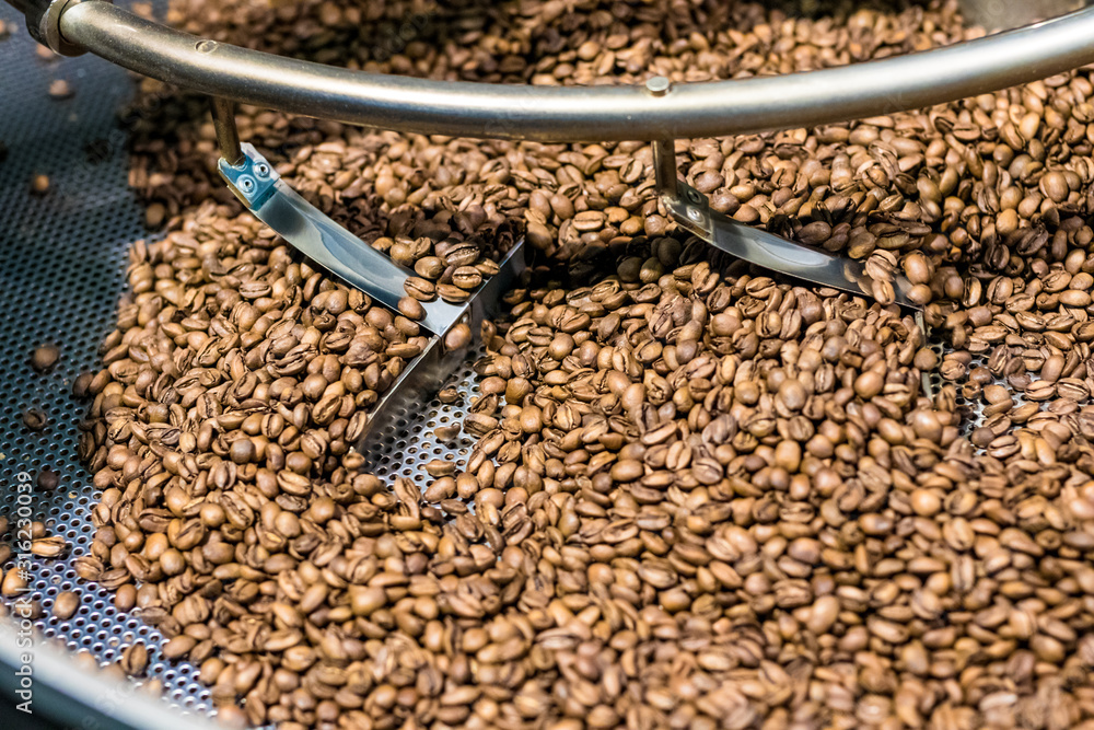 Fresh roasted coffee arabica beans have been cooled down in the roaster