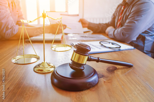 The mallet and brass scales are placed on the table in the lawyer's office for decorative purposes and are a symbol of justice in court decisions Fototapet