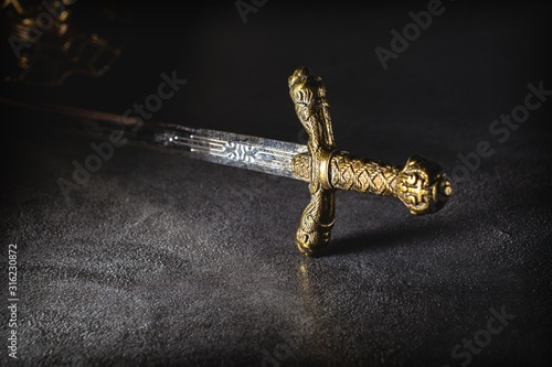 Knight's sword on a gray granite background