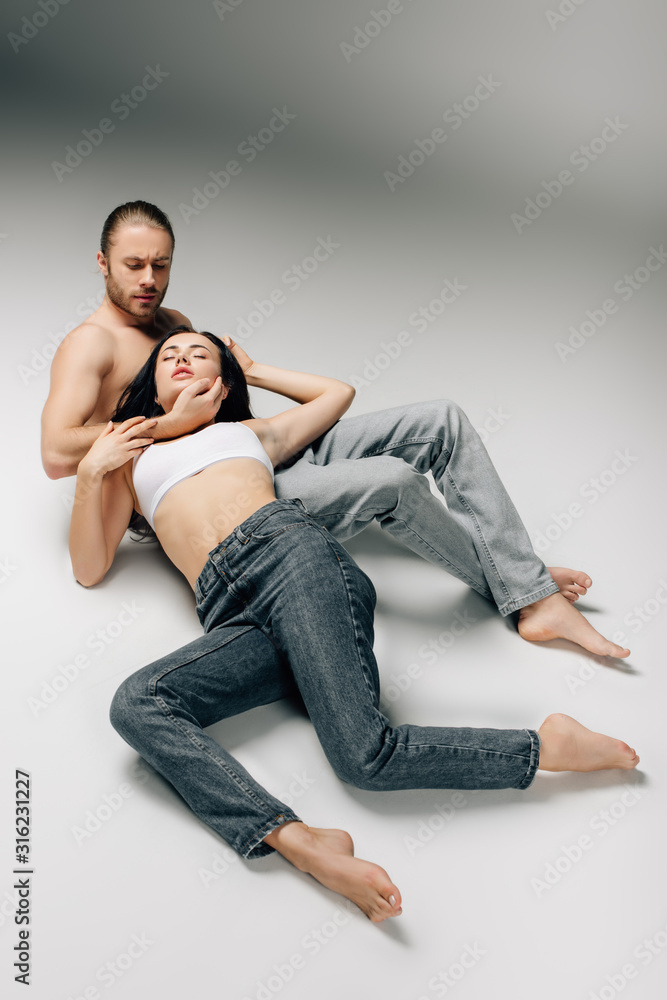 beautiful sexy couple in underwear and jeans lying on grey Stock Photo |  Adobe Stock