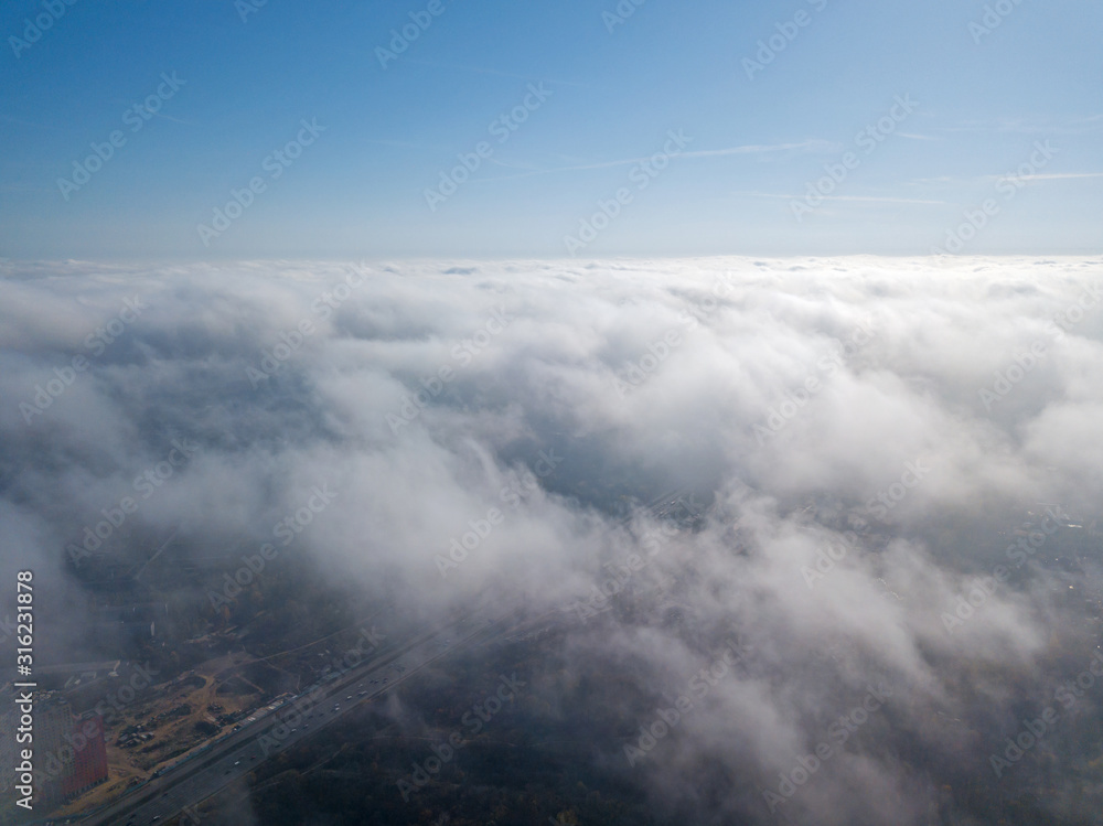 Aerial drone cityscape. Kiev city houses under rare clouds, top view.
