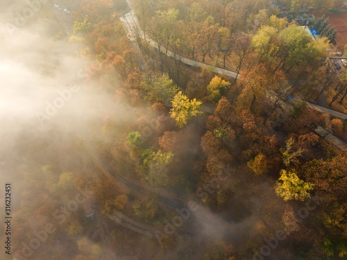 Fototapeta Naklejka Na Ścianę i Meble -  Aerial drone view. Kiev park in dense morning fog.