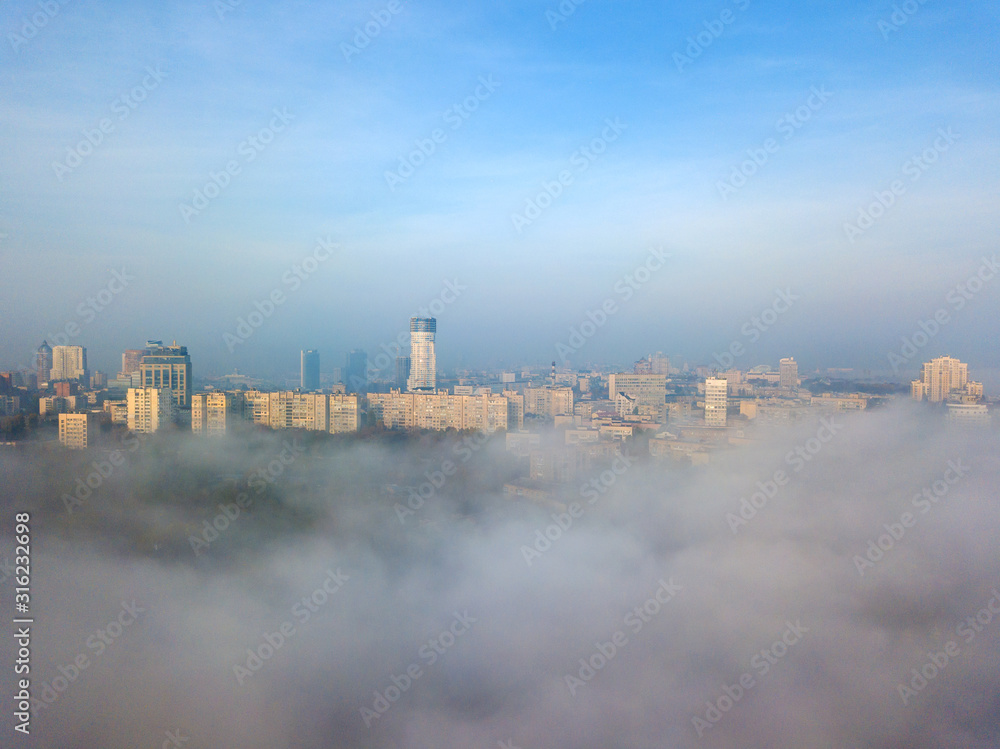 Aerial drone view. Kiev in the dense morning fog.