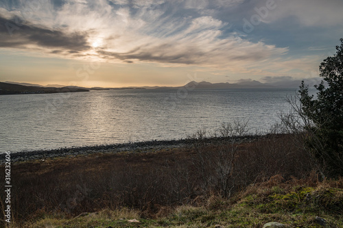 A bracketed HDR warm winter image across the inner sound to a distant Isle of Skye from the Applecross Peninsula  Scotland. 31 December 2019