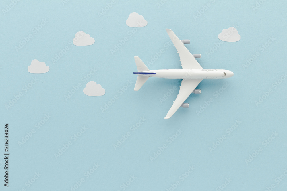White top view Airplane . Airplane clouds blue cloud sky background with copy space for your text. Flat lay. White top view Airplane . Airplane clouds blue cloud sky background with copy space for your text. Flat lay.