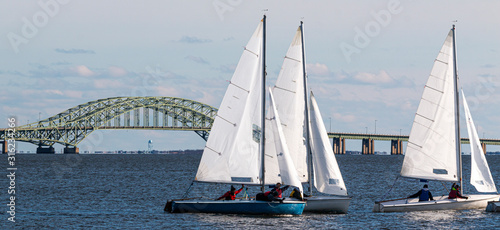 Three two person sailboats with The Great South Bay Bridge in December