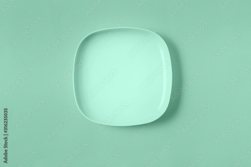 Food empty plate toned in trendy neo mint color, flat lay. Food empty plate toned in trendy neo mint color, flat lay.