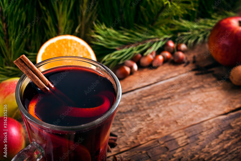 Christmas hot mulled wine with spices and fruits on a old wooden background. Autumn background, Christmas background. Copy space. Christmas hot mulled wine with spices and fruits on a old wooden background. Autumn background, Christmas background. Copy space.