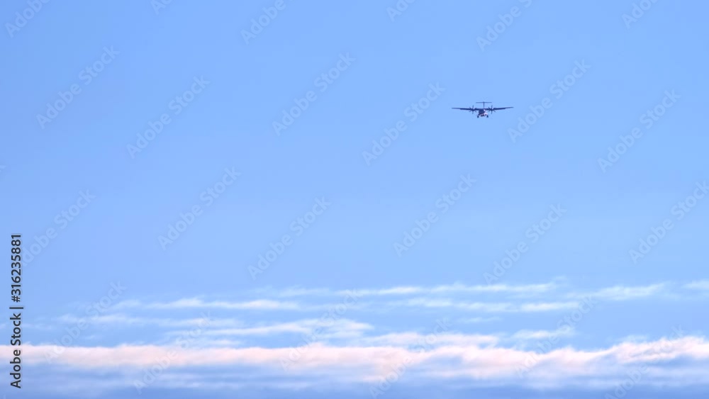 airplane in clear blue sky is landing. releasing the chassis. copy space airplane in clear blue sky is landing. releasing the chassis. copy space