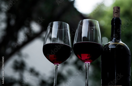 Food and drink  holidays party concept.  red wine in a glass on the bar  blurred background. Romantic dinner.