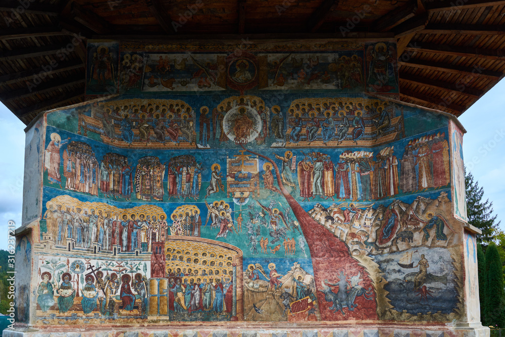 Obraz premium Voronet Monastery, founded in the 15th century, located in Voronet, Romania. Stone religious building of Christian Orthodox church built with painted walls.