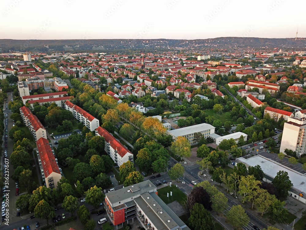 Low residential buildings in the city with red roofs. Aerial view.