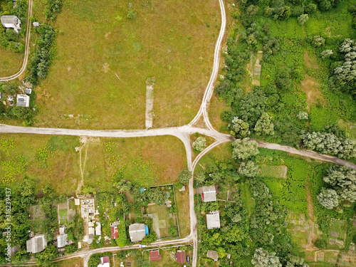 Aerial drone view. A dirt road on the edge of the village.