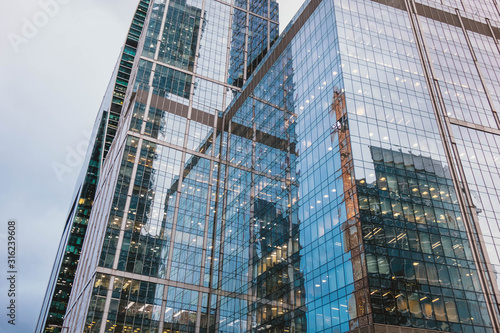 Modern skyscrapers close-up toned in blue color.