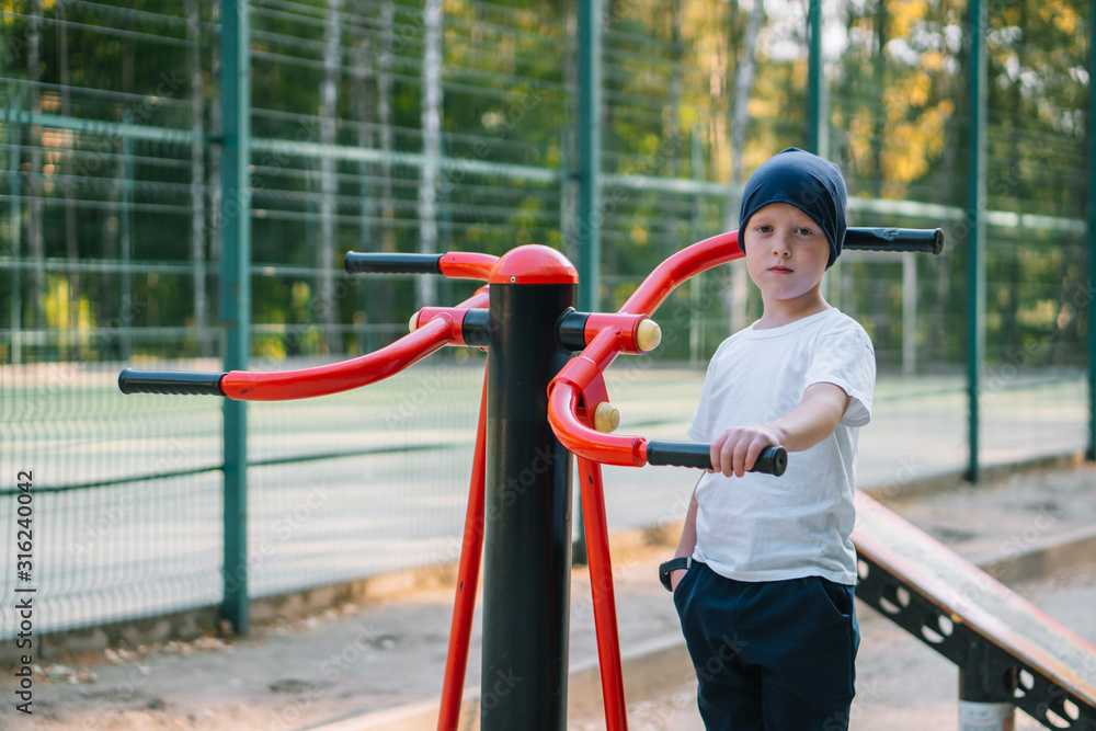 A boy on public street simulators. Little boy playing sports A boy on public street simulators. Little boy playing sports