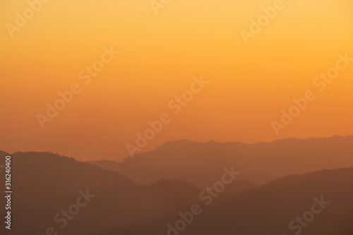 Sea of fog and mountain silhouette during sunrise in the morning at Doi Luang Chiang Dao.